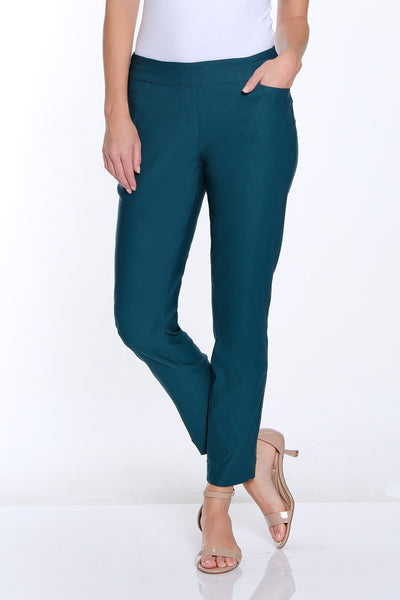 Woman wearing a white t-shirt and teal pants on a white background