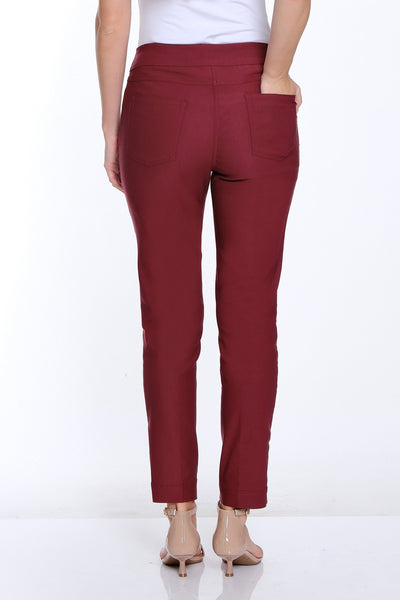 Woman wearing maroon pants and a white top on a white background