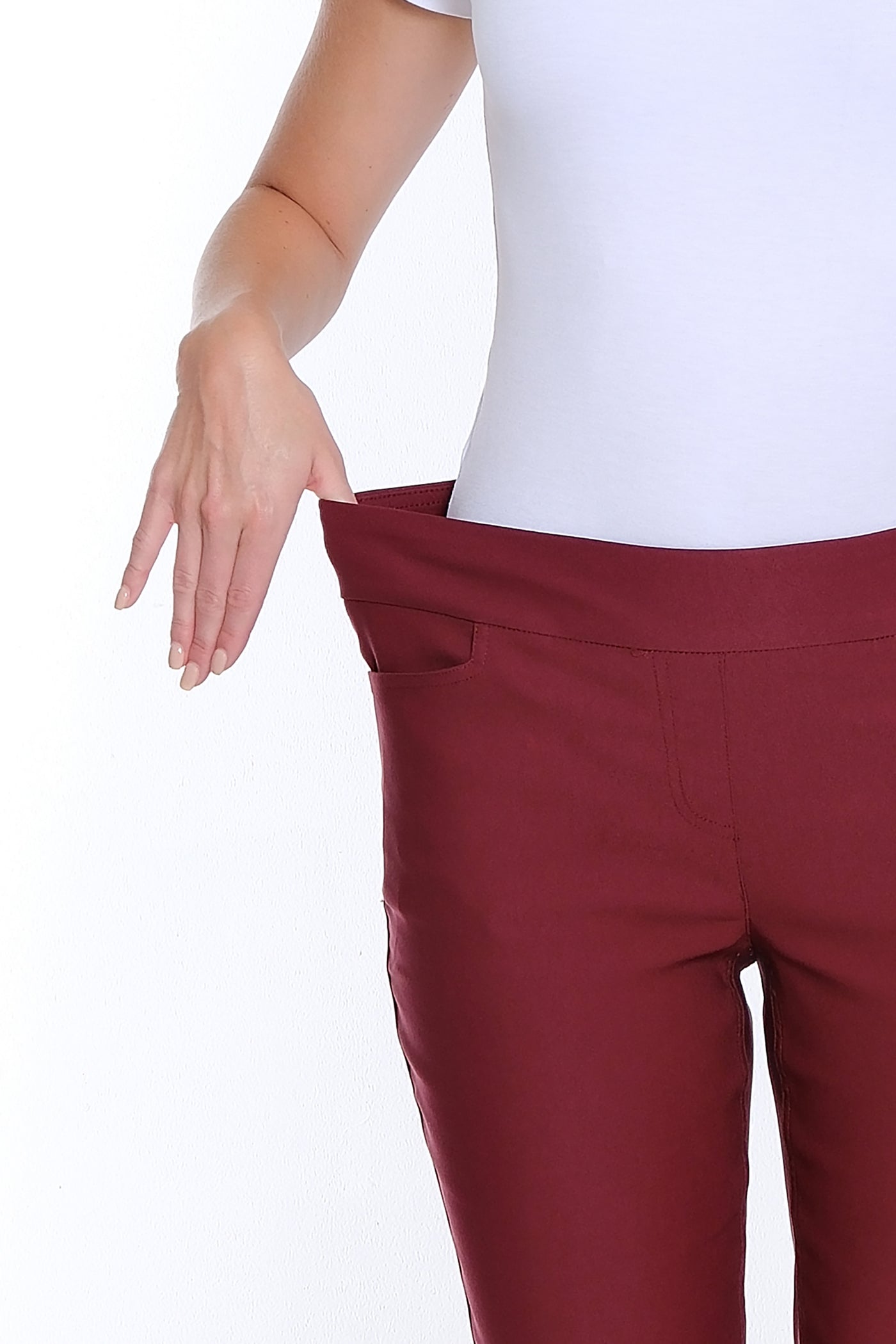 Maroon pants worn by a person on a white background