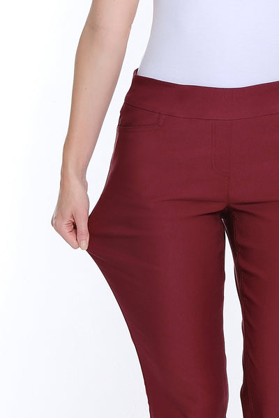 Maroon pants worn by a person on a white background