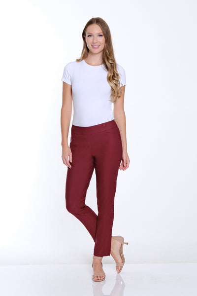 Woman wearing a white t-shirt and maroon pants on a white background