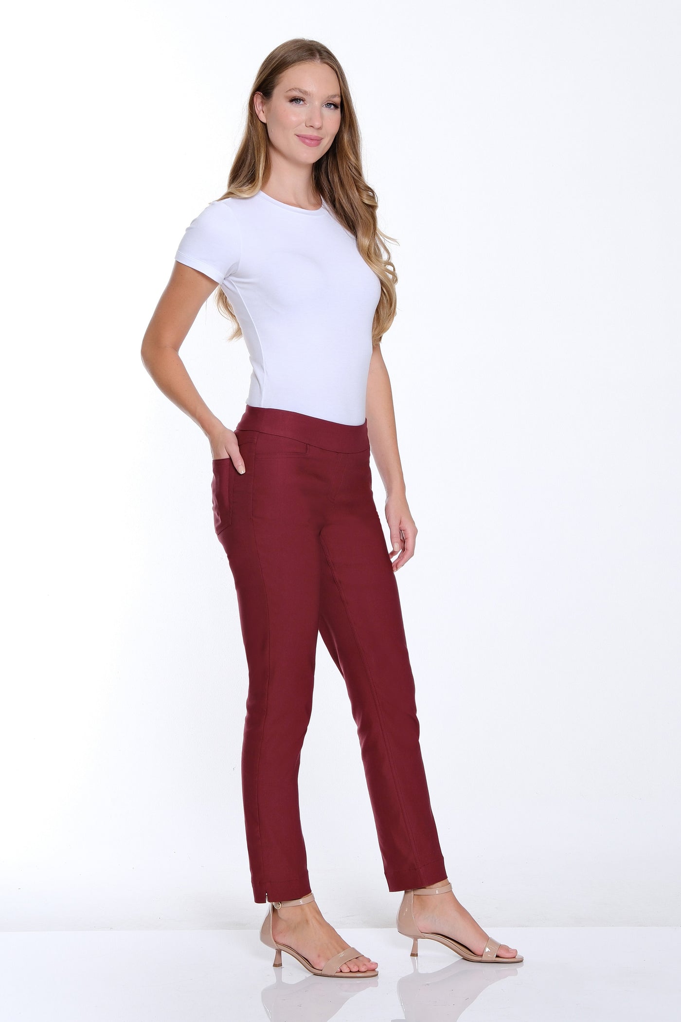 Woman wearing a white t-shirt and red pants on a white background