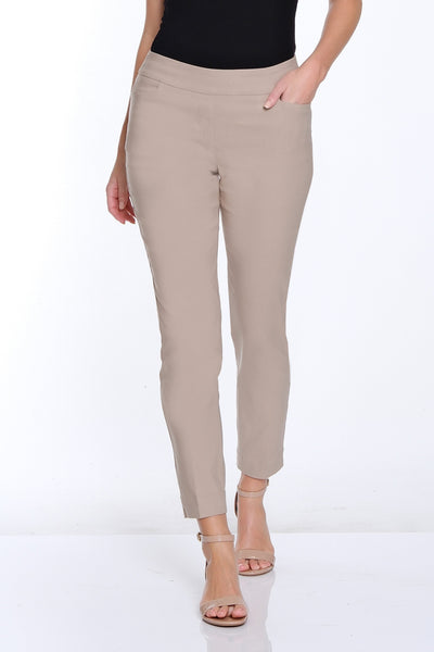 Woman wearing a black top and beige pants on a white background