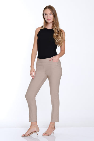 Woman wearing beige pants and a black top on a white background