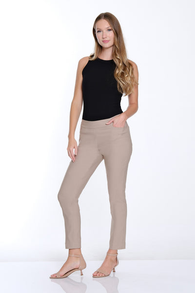 Woman wearing beige pants and a black top on a white background