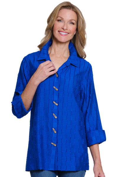 Woman wearing a blue shirt with buttons on a white background