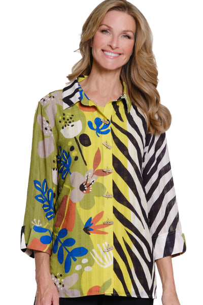 Woman wearing a colorful patterned blouse with a zebra design on a white background
