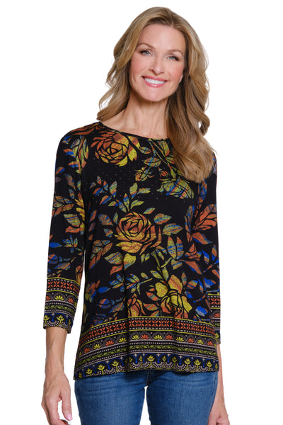 Woman wearing a black floral patterned top on a white background