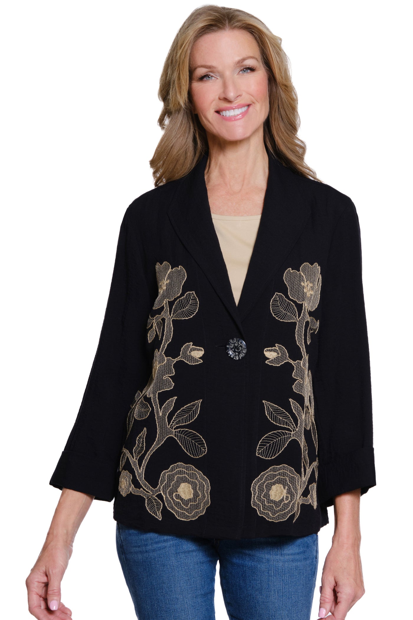 Woman wearing a black blazer with floral embroidery on a white background