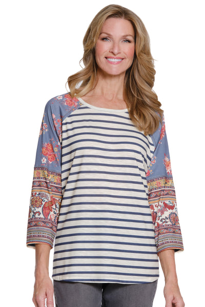 Woman wearing a striped shirt with colorful sleeves on a white background