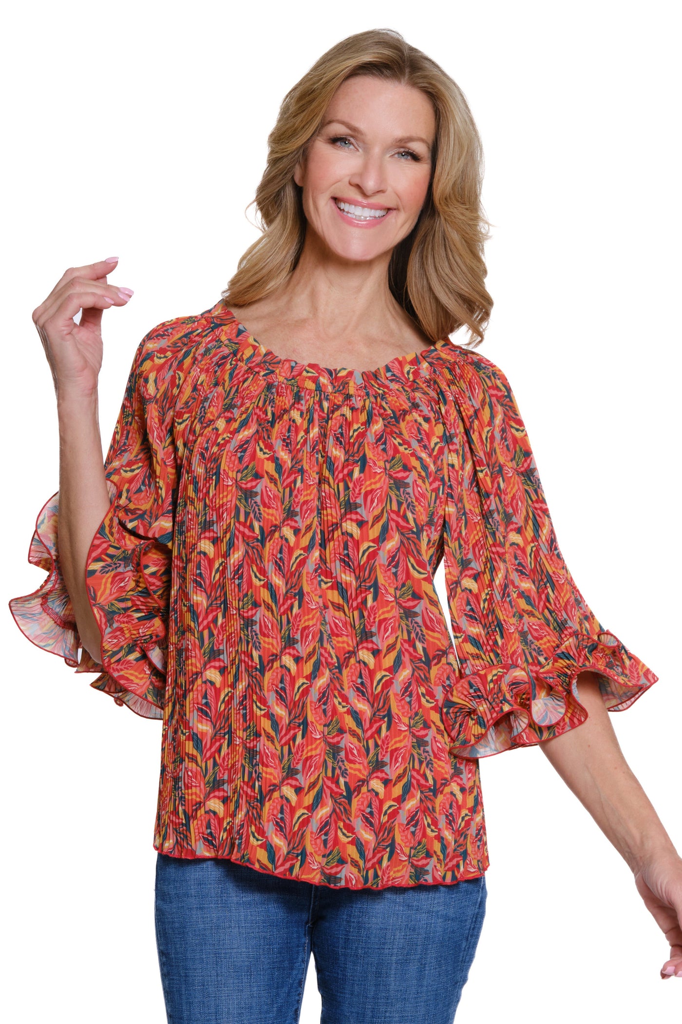 Woman wearing a colorful patterned blouse with ruffled sleeves on a white background