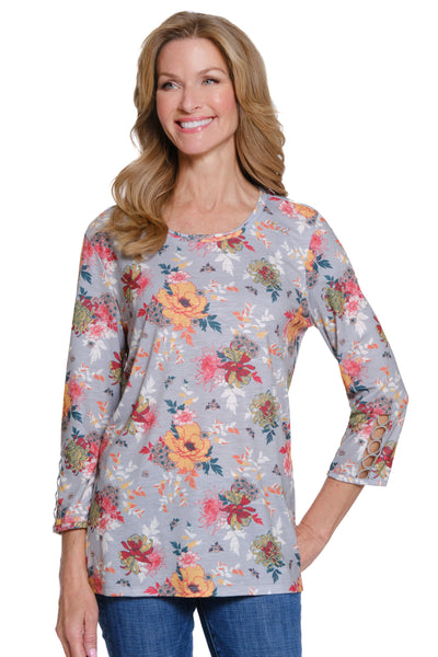Woman wearing a floral long-sleeve top on a white background