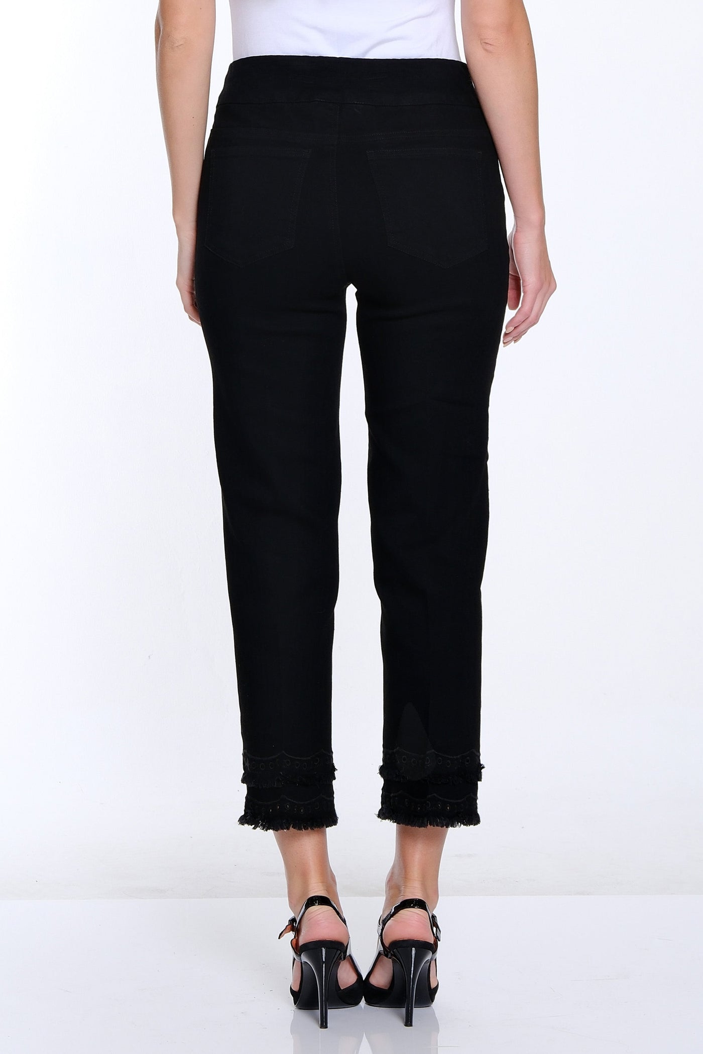 Woman wearing a white t-shirt and black pants on a white background