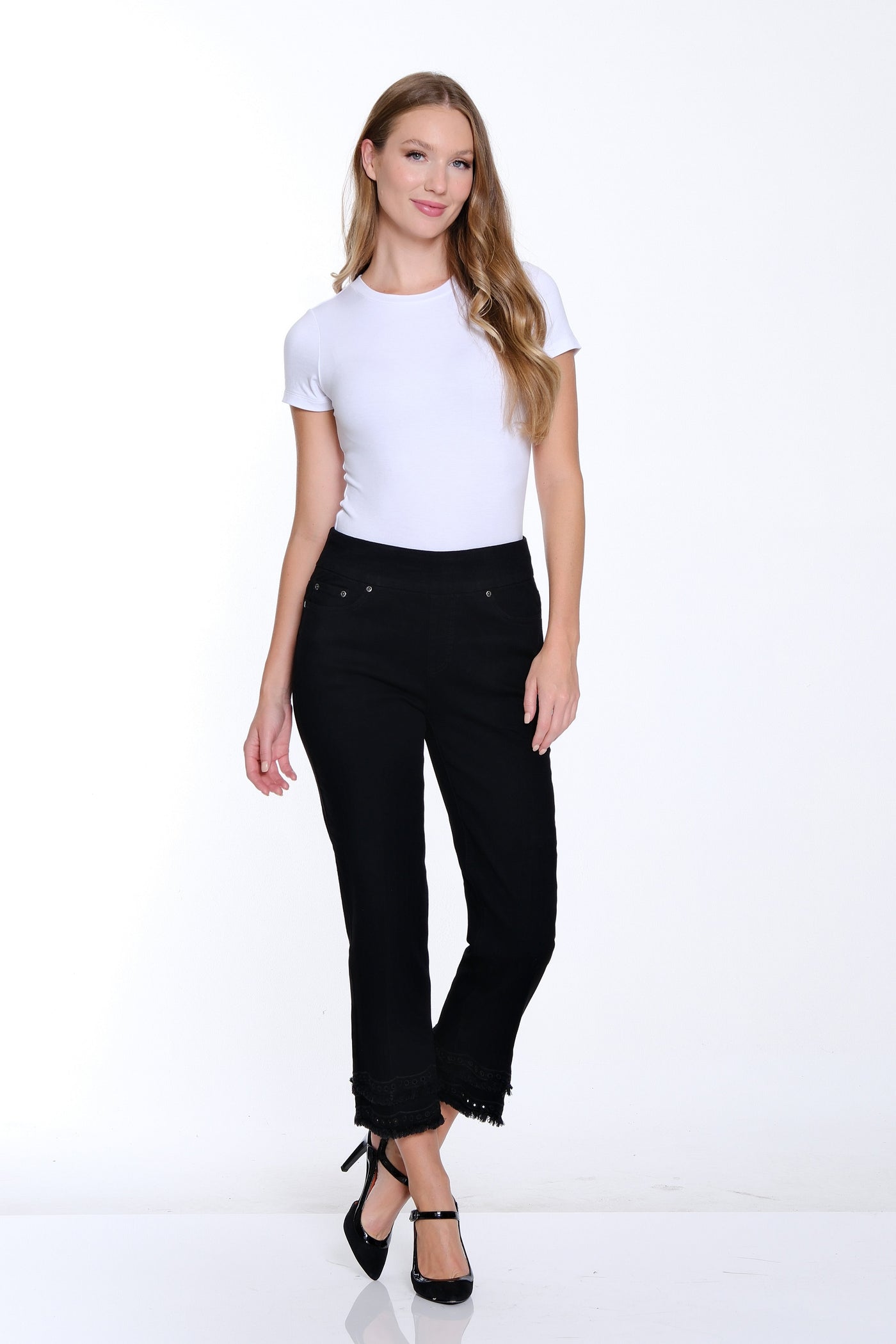 Woman wearing a white t-shirt and black pants on a white background
