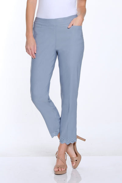 Woman wearing a white t-shirt and light blue pants on a white background