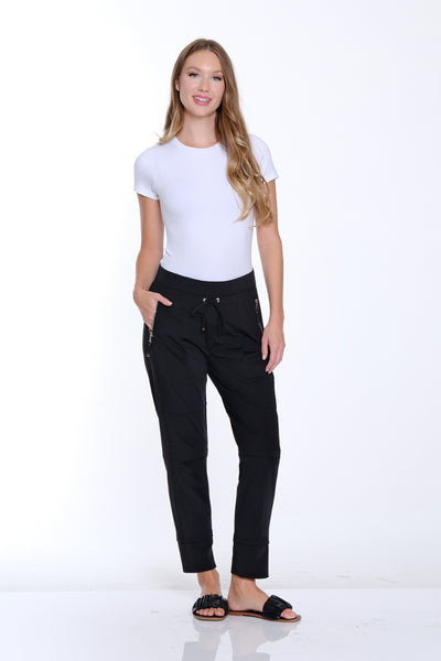 Woman wearing a white t-shirt and black pants on a white background