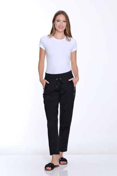 Woman wearing a white t-shirt and black pants on a white background