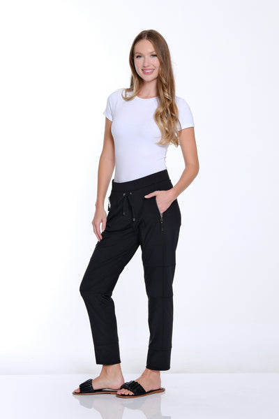 Woman wearing a white t-shirt and black pants on a white background