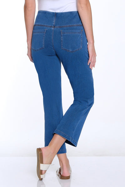 Woman wearing blue jeans and a white top on a white background