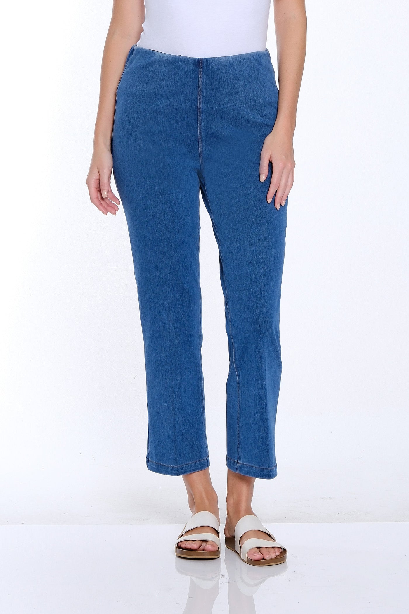 Woman wearing a white t-shirt and blue jeans on a white background