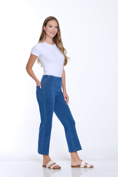 Woman wearing a white t-shirt and blue jeans on a white background