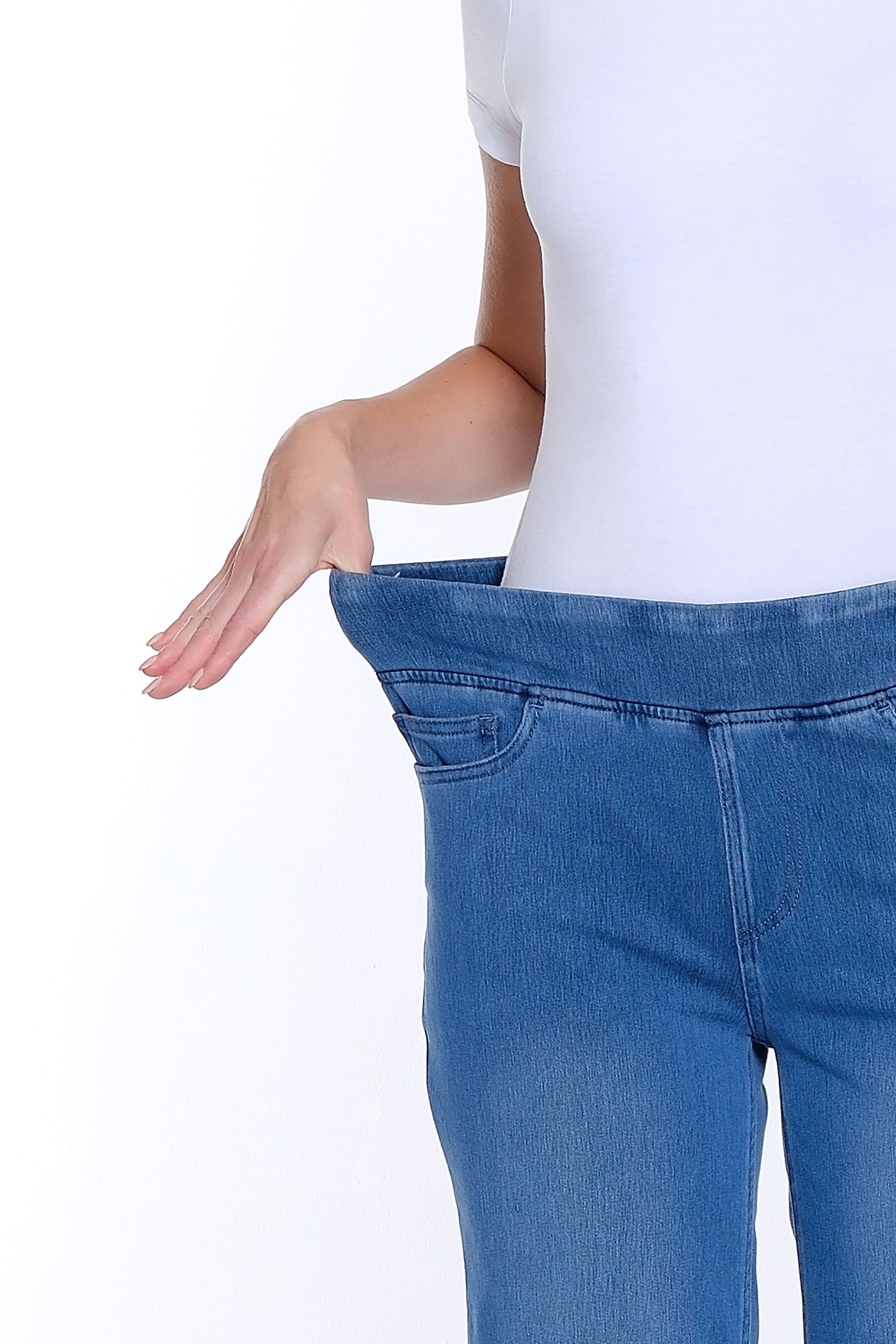 Person wearing a white t-shirt and blue jeans on a white background