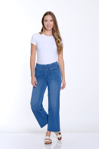 Woman wearing a white t-shirt and blue jeans on a white background