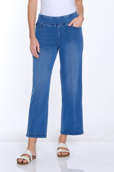Woman wearing a white t-shirt and blue jeans on a white background