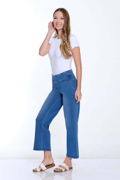 Woman wearing a white t-shirt and blue jeans on a white background
