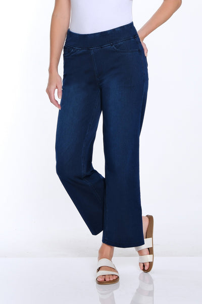 Woman wearing a white t-shirt and blue jeans on a white background