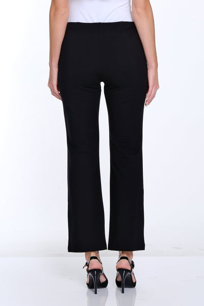 Person wearing a white top and black pants on a white background