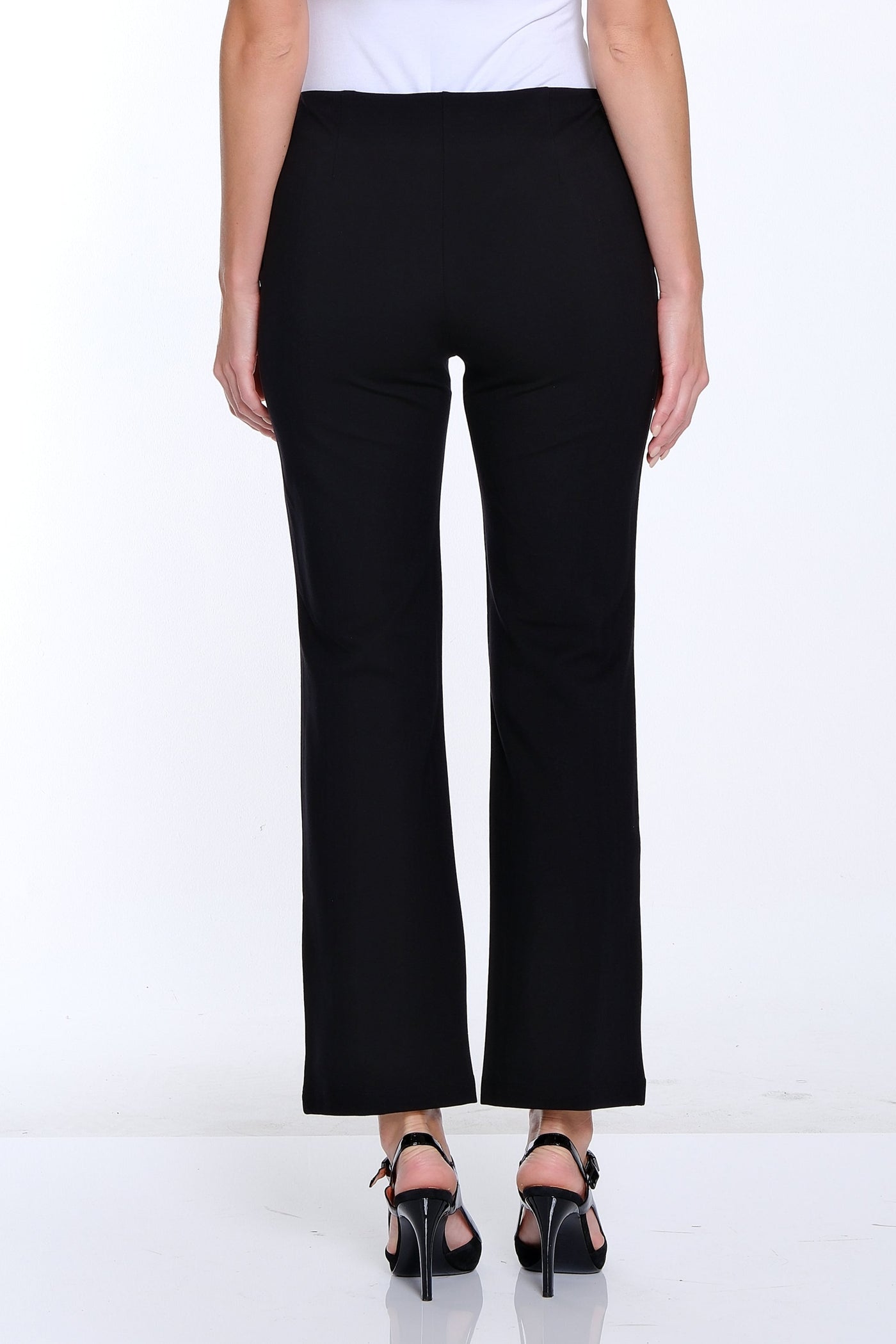 Person wearing a white top and black pants on a white background