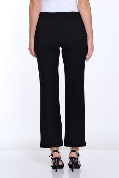 Person wearing a white top and black pants on a white background