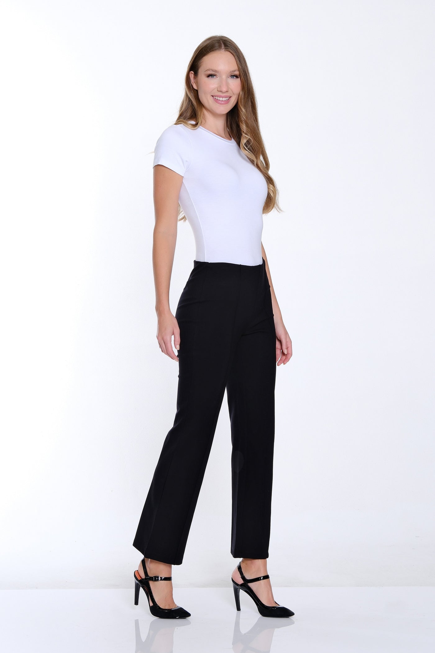 Woman wearing a white t-shirt and black pants on a white background