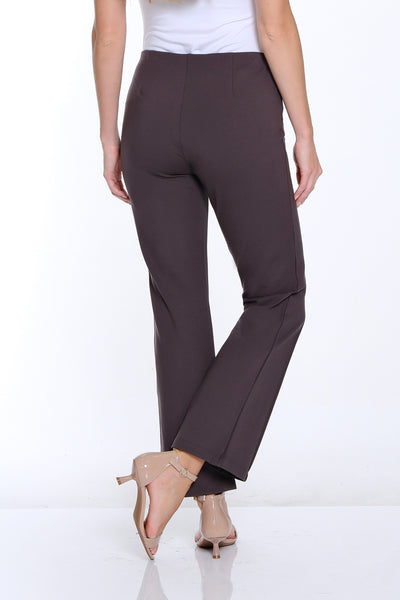 Woman wearing a white top and brown pants on a white background