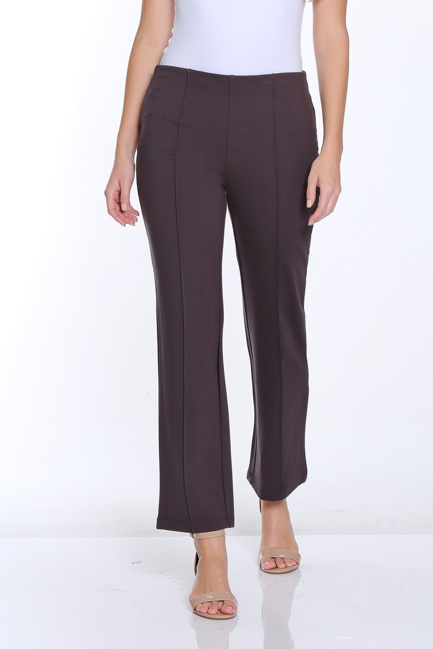 Woman wearing a white top and brown pants on a white background