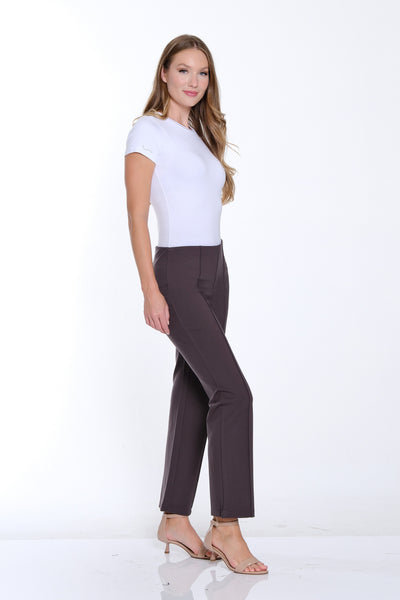 Woman wearing a white top and dark pants on a white background