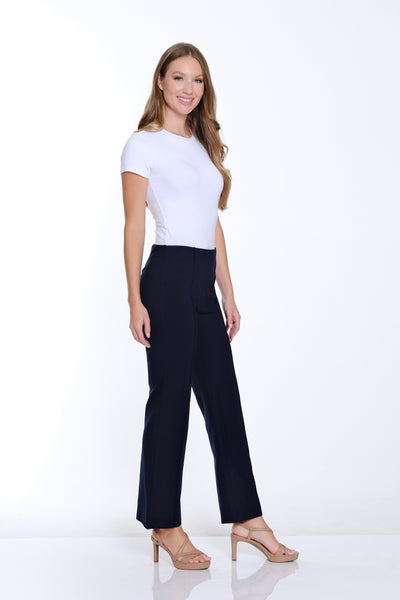 Woman wearing a white t-shirt and black pants on a white background