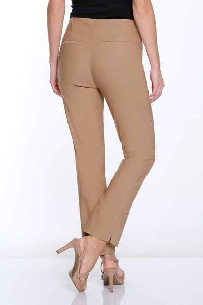 Woman wearing a black top and beige pants on a white background