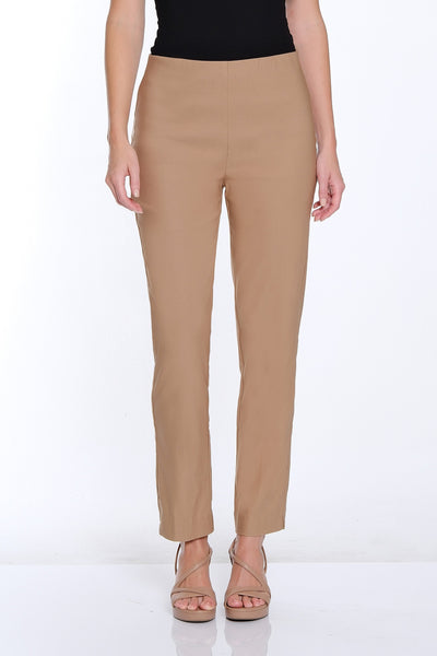 Woman wearing a black sleeveless top and beige pants on a white background