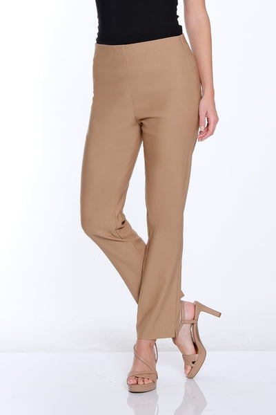 Woman wearing a black top and beige pants on a white background