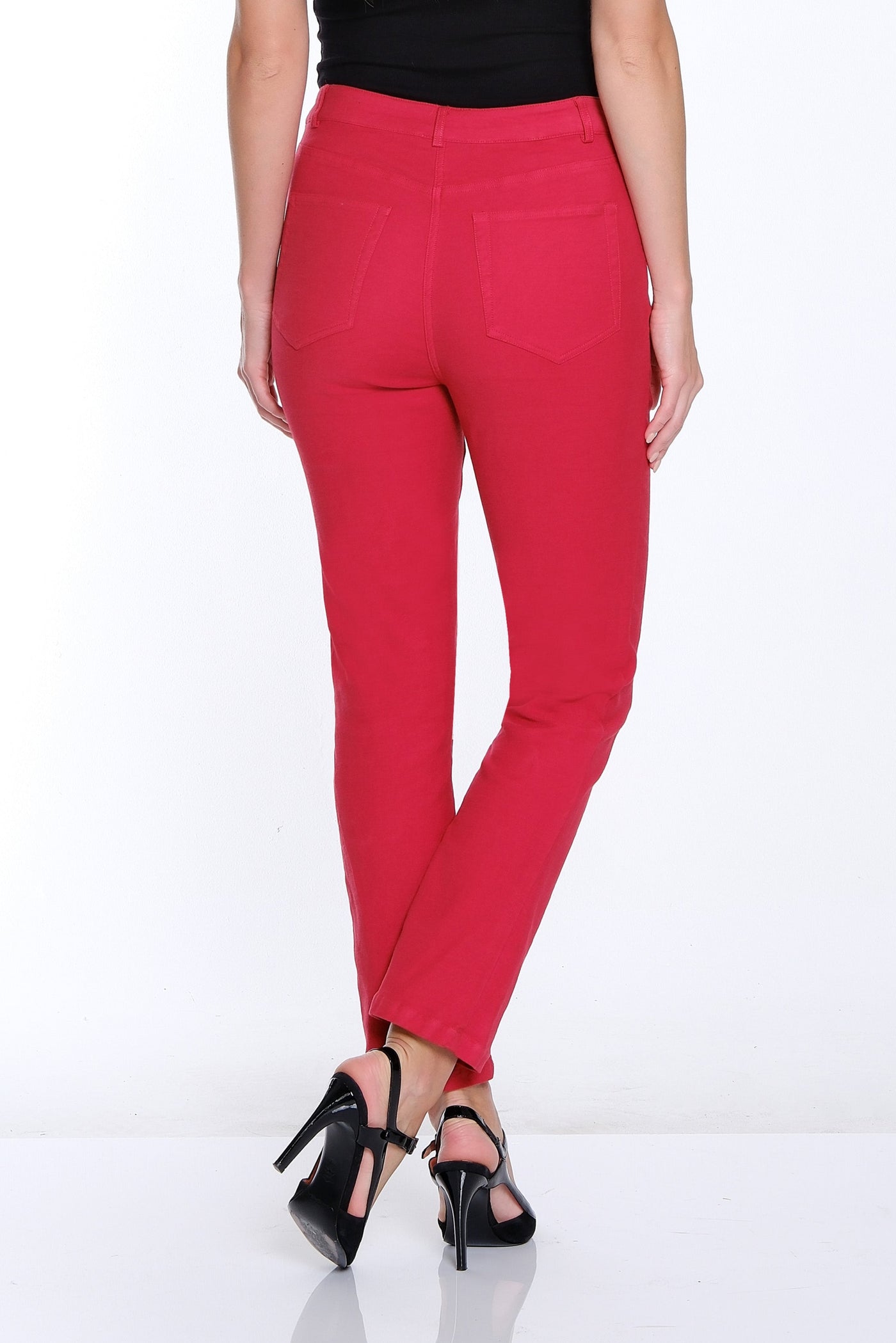 Woman wearing red pants and a black top on a white background