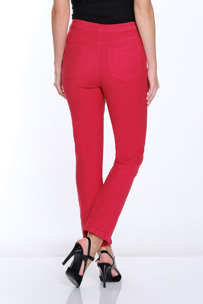 Woman wearing red pants and a black top on a white background