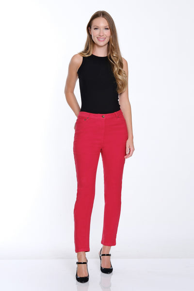 Woman wearing a black top and red pants on a white background