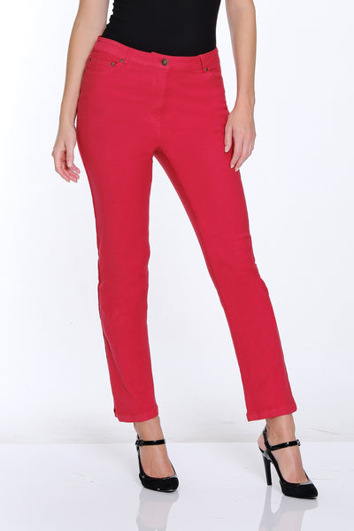 Woman wearing a black sleeveless top and red pants on a white background
