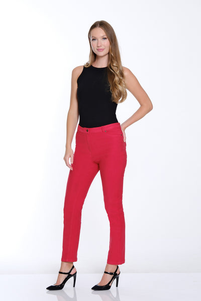 Woman wearing a black top and red pants on a white background