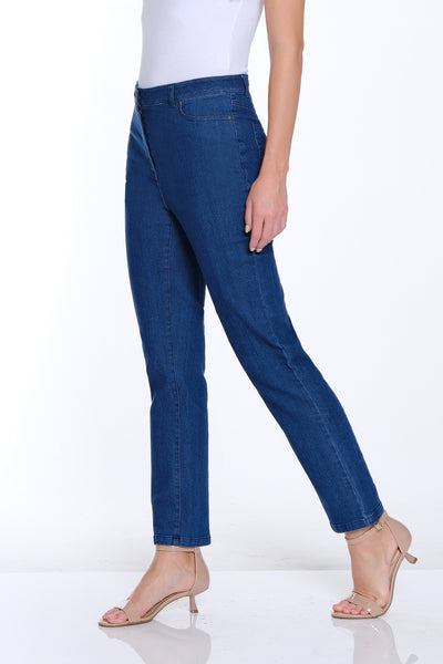 Woman wearing a white t-shirt and blue jeans on a white background