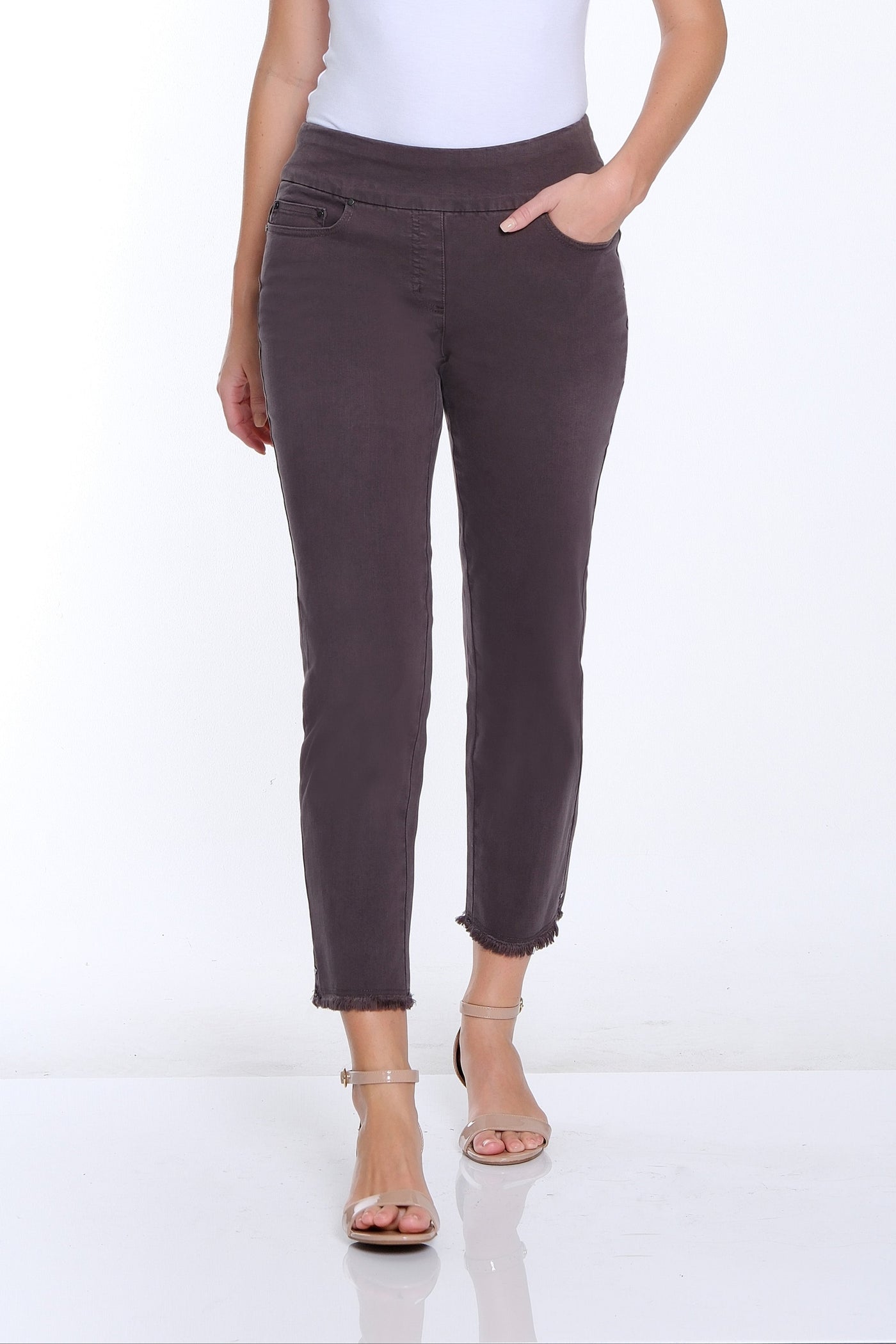 Woman wearing a white t-shirt and brown pants on a white background