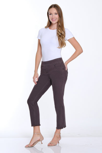 Woman wearing a white t-shirt and dark pants on a white background