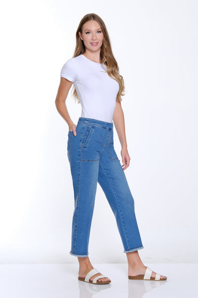 Woman wearing a white t-shirt and blue jeans on a white background